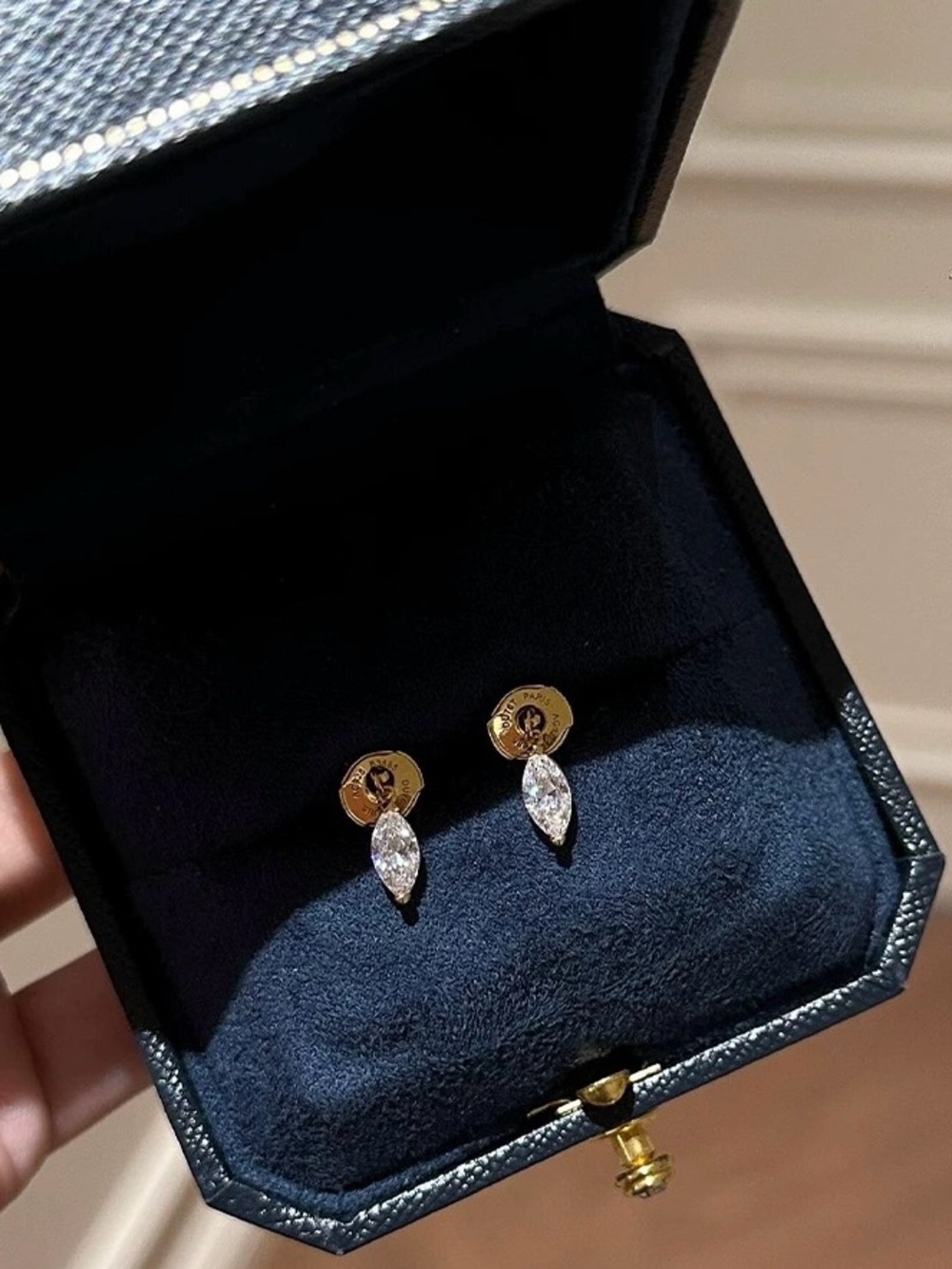 Marquise cut diamond studs in gold tone